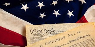 The Declaration of Independence laid on an American flag