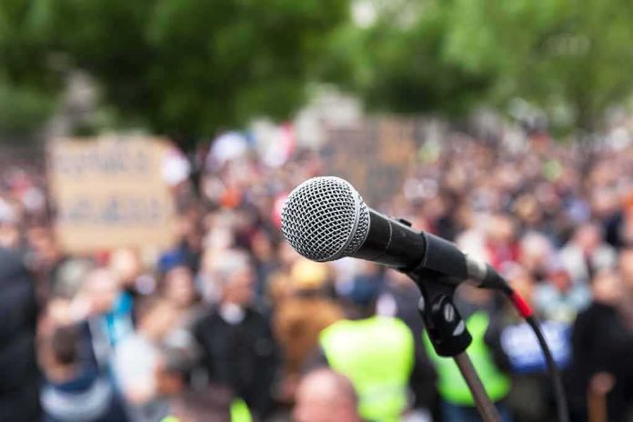 microphone on stand in front of a blurred crowd