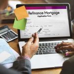 The National Debt Number EVERY Politician Is Hiding From You Laptop displaying refinance mortgage application form