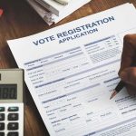 This DMV ‘Glitch’ Registers Noncitizens to VOTE Person filling out a voter registration application form