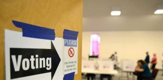 Voting sign on door leading to polling place