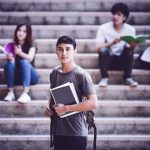 DSA’s Gen Z Takeover Becomes Major Threat to Conservatives Student holding notebooks on campus steps