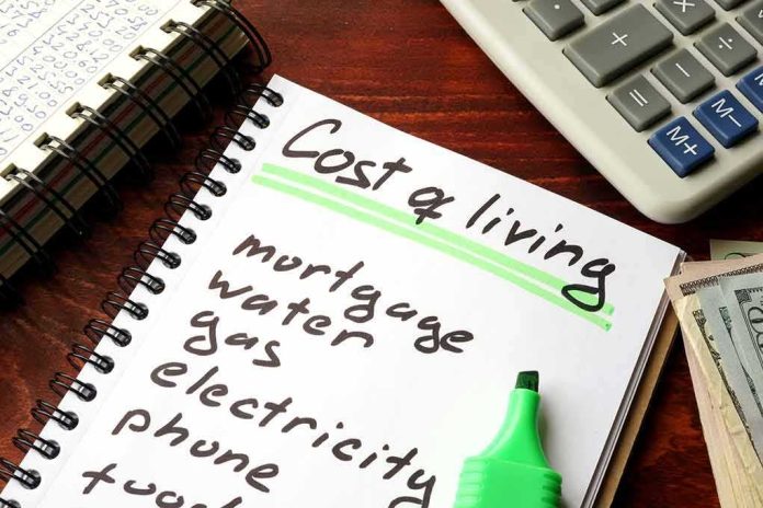shutterstock_593390591-1 Budget notebook with cost of living list, calculator, and cash