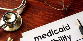 Medicaid eligibility form with stethoscope and pen on desk