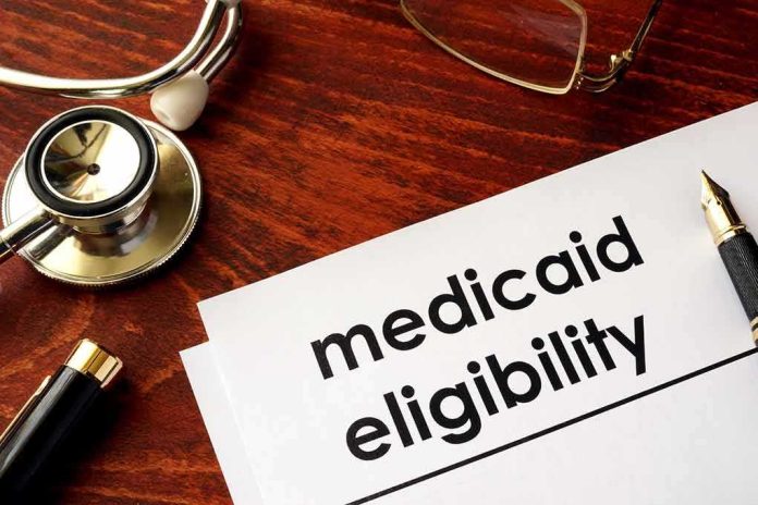 shutterstock_640488934 Medicaid eligibility form with stethoscope and pen on desk