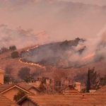 This Fire Was Started by a Person Not Nature Wildfire burns on hillside near suburban homes