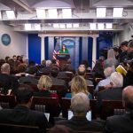 Media Blacklist Shocks Washington Press secretary at podium addressing reporters in briefing room