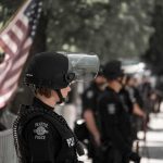Recall Frenzy Fizzles — What Went Missing? police officer in riot gear standing in a line
