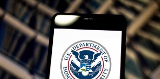 Border Agents Seize Phones With PRIVILEGED Files U.S. Department of Homeland Security logo on smartphone.