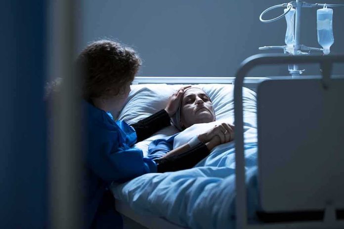 Patient in hospital bed with visitor holding their hand