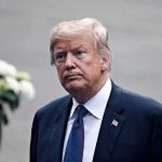 Trump KNEW Energy Prices Could Jump man in a suit with an American flag pin