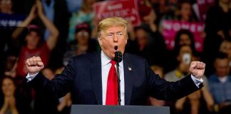 Trump’s Iran Remark Sets Off California FURY Donald Trump speaking at a rally podium with arms raised