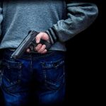 Transgender Suspect Tied to Canadian Mass Shooting ARRESTED person holding a handgun behind their back