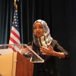 Omar’s Husband SNAPS When Asked Where She Is Ilhan Omar speaking at a podium with a microphone