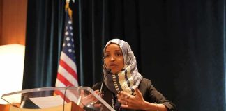 Omar’s Husband SNAPS When Asked Where She Is Ilhan Omar speaking at a podium with a microphone