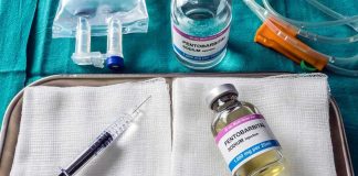 Medical tray with syringe and pentobarbital vials on gauze