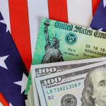$6.25B Going Into Kids’ Trump Accounts U.S. Treasury check and hundred dollar bills on American flag