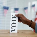 Alaska Democrat’s Win Could Be BLOCKED Hand placing a ballot into a wooden ballot box