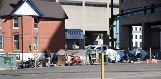 Homeless encampment with tents along a city street