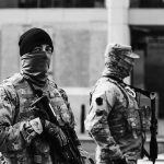 Commandos Wore DISGUISES Inside Kabul Two armed soldiers in tactical gear standing guard on a city street