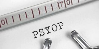 UK Accused of Tracking Online Government Critics Typewriter typing the word PSYOP on white paper