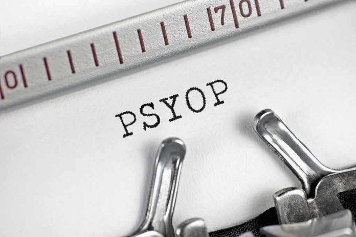 shutterstock_1924720262 Typewriter typing the word PSYOP on white paper
