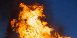 Tourist Office Goes Up in FLAMES Large flames against a dark blue sky