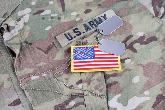 shutterstock_513453070 U.S. Army uniform with dog tags and American flag patch