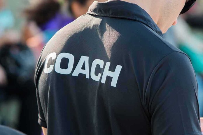 shutterstock_582703915 Coach wearing a black shirt with bold lettering