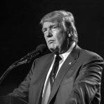 Why Trump Says Polls Want You HOME Donald Trump speaking at a microphone in a black-and-white photo