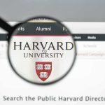 Harvard Liberals FIGHT Plan to Hire Conservatives Magnifying glass highlighting Harvard University website header