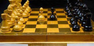Chessboard labeled Putin and Biden, pieces set up.