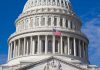 U.S. Capitol dome with American flag flying.