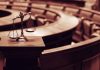 Scales of justice in an empty courtroom.