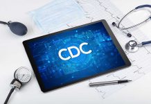 Tablet with CDC logo surrounded by medical equipment