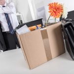 Worker packing up his belongings after being fired.