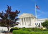 US Supreme Court building with American flag flying
