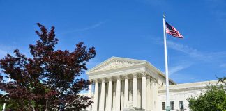 US Supreme Court building with American flag flying
