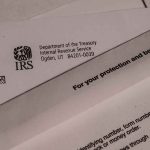 IRS letters and envelopes on a table.