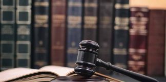 Gavel and open book in library setting