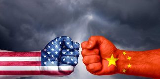 USA and China flags on clenched fists facing off