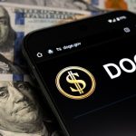 Smartphone displaying Doge logo on hundred dollar bills