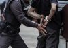 Police officer handcuffing an individual behind their back