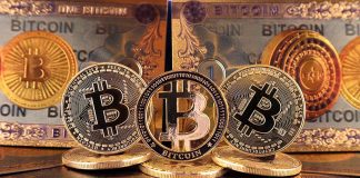 Bitcoin coins and bills displayed closely