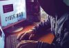 Hacker typing at desk with Cyber War screen