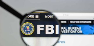 "FBI website shown through magnifying glass."
