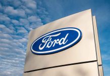 Ford logo sign against blue sky