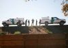 Border Patrol vehicles and agents on a ridge