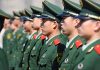 Chinese military personnel standing in formation.