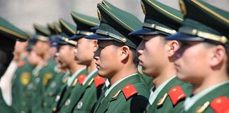 Chinese military personnel standing in formation.